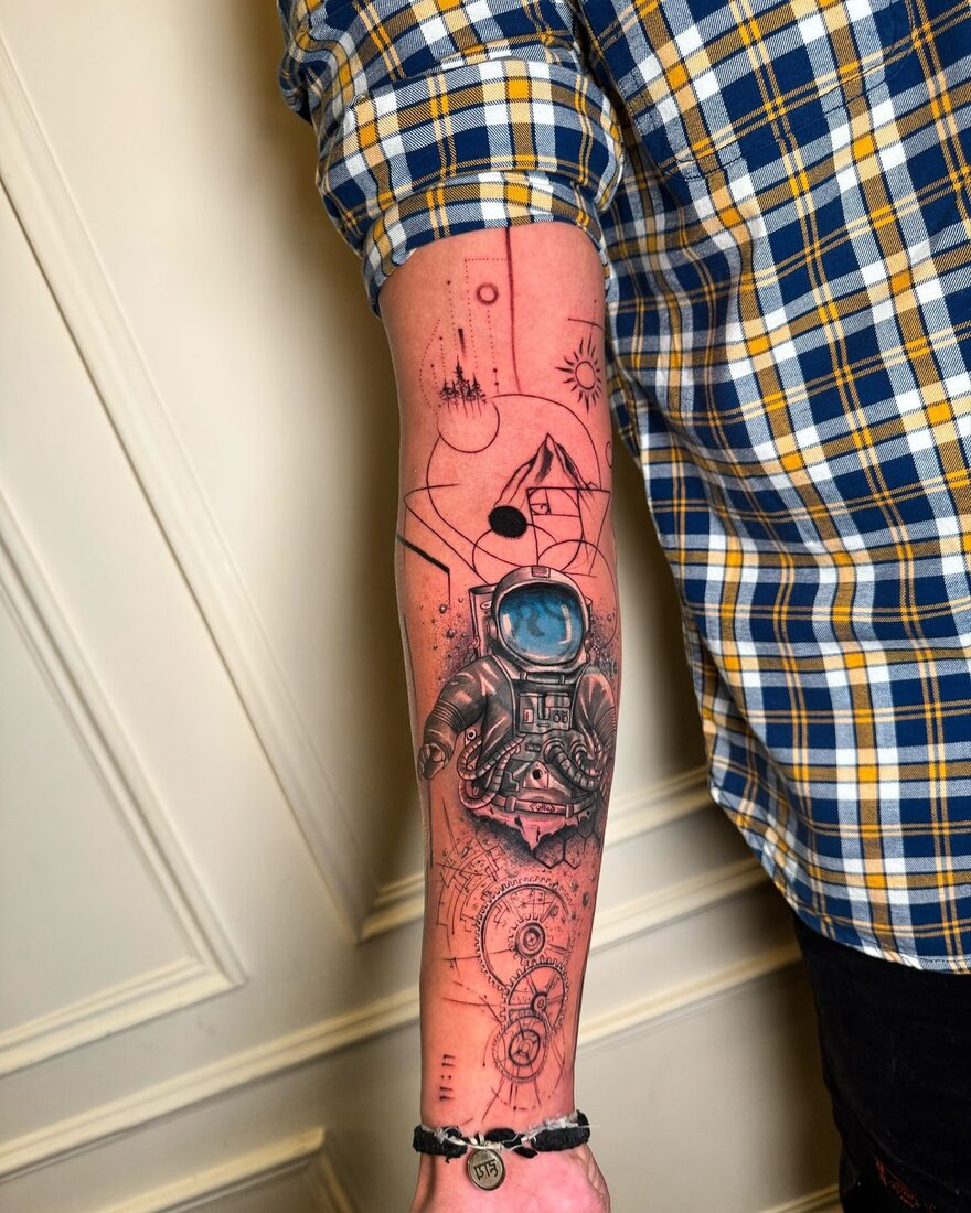 Fine-line cosmonaut sleeve tattoo by The Quinted in New Delhi