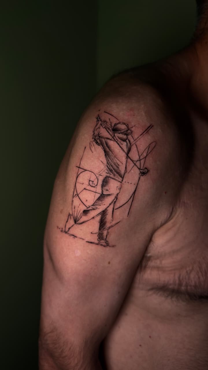 Sketch-style cricket player shoulder tattoo by The Quinted