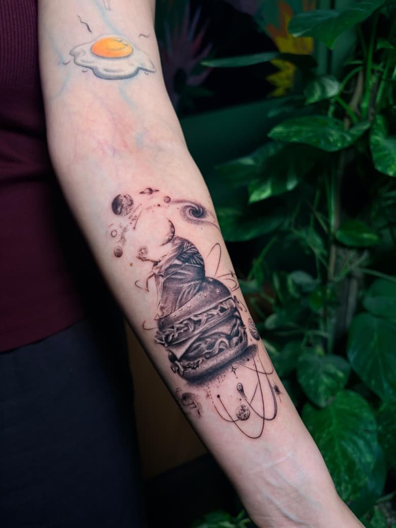 Micro realism burger and planets forearm tattoo by The Quinted in New Delhi